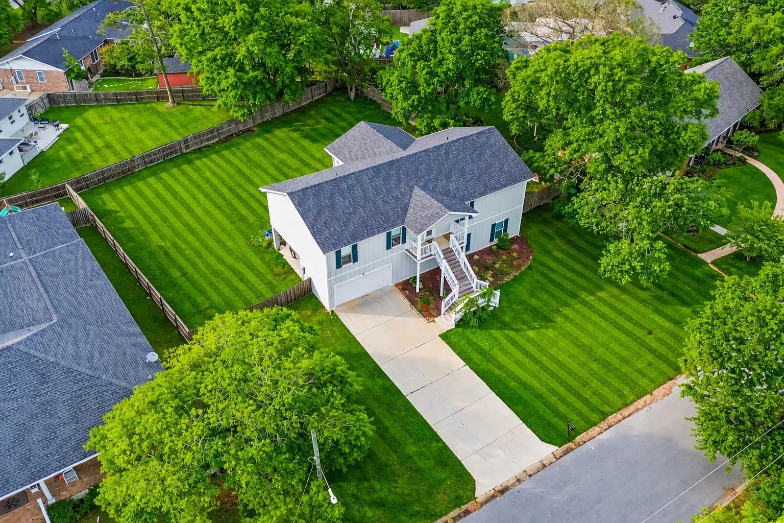 Aerial of suburban home with manicured lawn