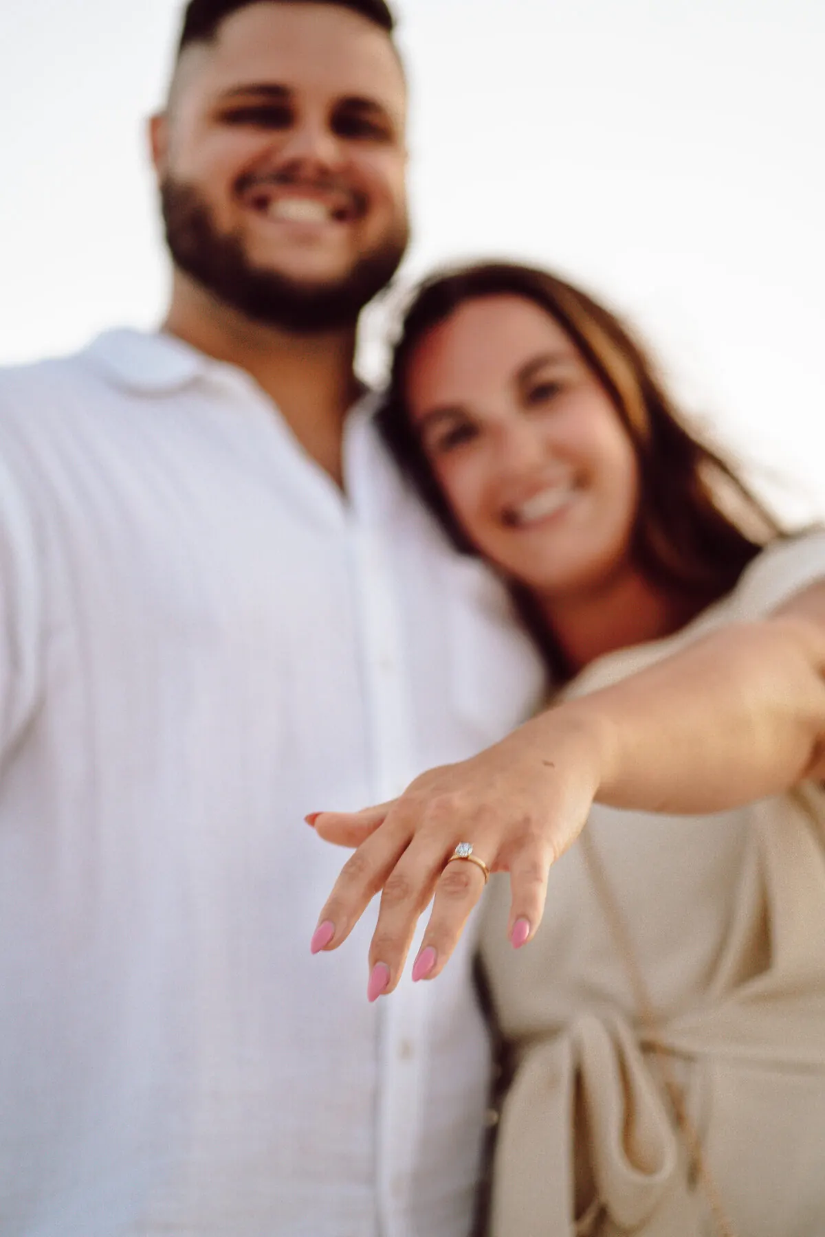 Engaged couple holding each other